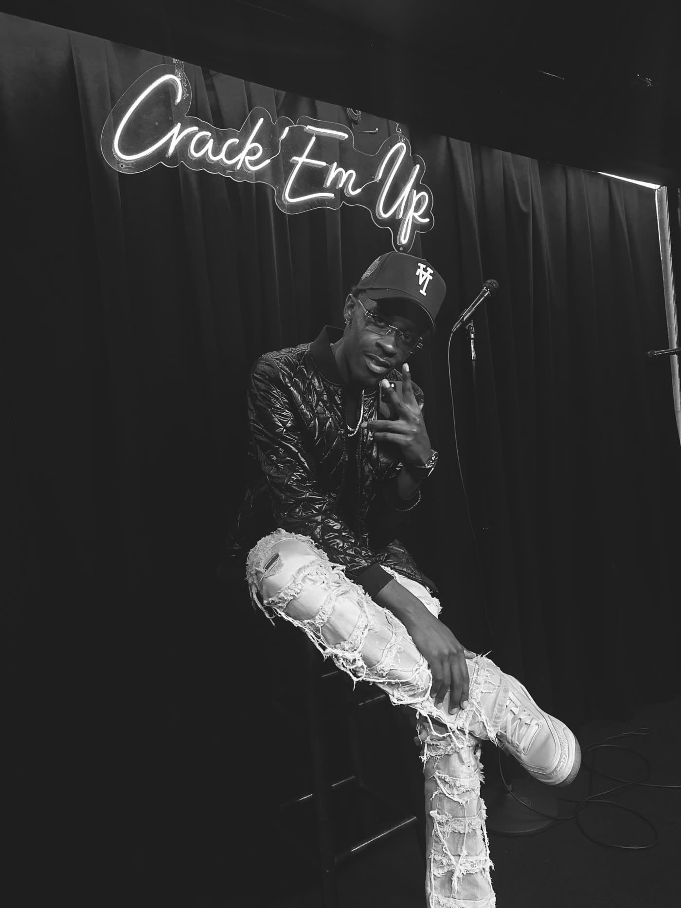 Bobby Starr mid-set beneath a neon Crack 'Em Up sign